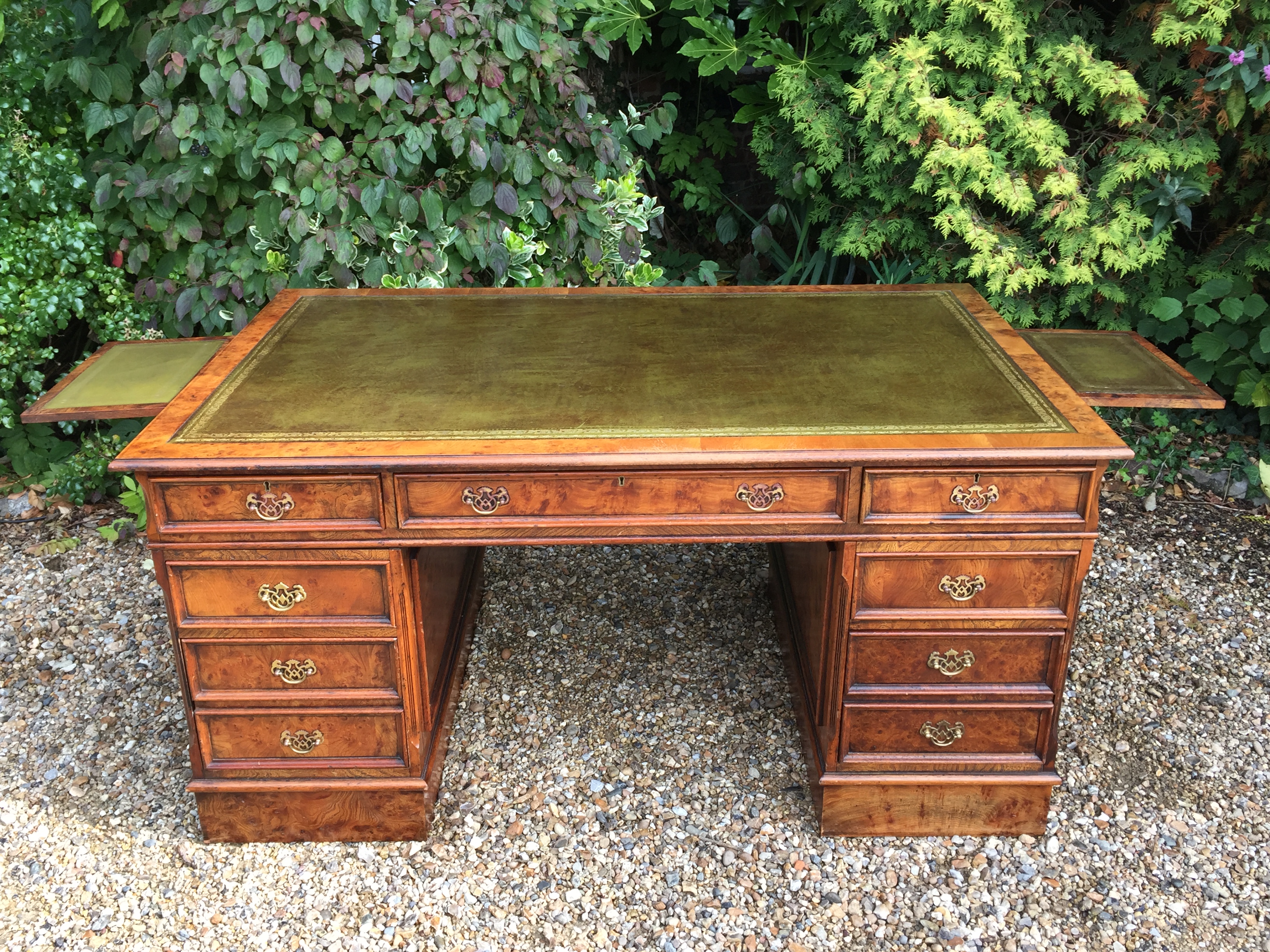 A GEORGE III DESIGN POLLARD OAK PARTNERS DESK The green tooled leather writing surface, above an