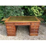 A GEORGE III DESIGN POLLARD OAK PARTNERS DESK The green tooled leather writing surface, above an