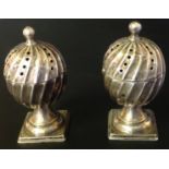 A PAIR OF VICTORIAN HALLMARKED SILVER PEPPERETTES With a spiralling fluted design, urn shaped with