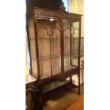 A CHIPPENDALE REVIVAL MAHOGANY DISPLAY CABINET  The shell carved cartouche and scroll carved frieze,