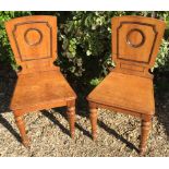 HOLLAND & SON, A PAIR OF VICTORIAN OAK HALL CHAIRS With shaped moulded backs, over solid seats,