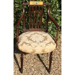 A REGENCY PERIOD MAHOGANY OPEN ARMCHAIR With a painted panel of trumpets and foliage, above a