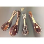 A GROUP OF FOUR ANTIQUE TORTOISESHELL MINIATURE INSTRUMENTS The wooden bodies having tortoiseshell