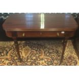 AN EARLY 19TH CENTURY MAHOGANY FOLD OVER TEA TABLE With a single drawer, raised on turned legs