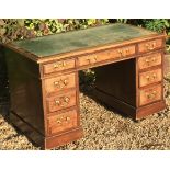 A LATE VICTORIAN MAHOGANY TWIN PEDESTAL DESK The distressed green leather writing surface, above