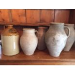 HARRODS, A LATE 19TH CENTURY STONEWARE FLAGON Along with four antique terracotta jugs.