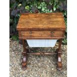 A REGENCY ROSEWOOD GAMES/WORK TABLE With fold over top opening to reveal green tooled leather top,