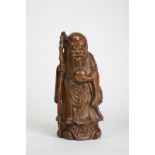 AN 18th CENTURY, CARVED BAMBOO FIGURE OF  'DONG FANGSHUO'  The standing figure of the immortal