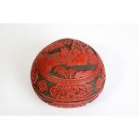 A LATE 18th CENTURY CARVED CINNABAR LACQUER PEACH-FORM BOX AND COVER The cinnabar red lacquer