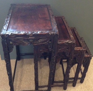 A NEST OF FOUR EARLY 20th CENTURY CHINESE HARDWOOD TABLES Carved in high relief with dragons and - Image 2 of 2