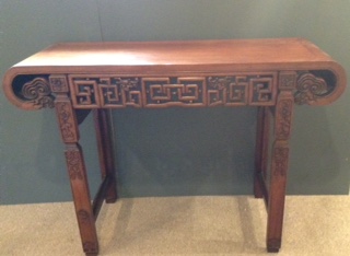 A 20th CENTURY CHINESE TEAK ALTAR TABLE With overscrolled end and carved and pierced frieze,