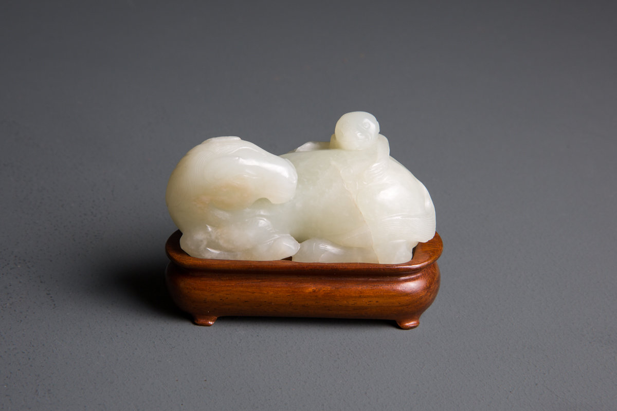 AN 18th CENTURY, PALE CELADON JADE RECUMBENT HORSE AND MONKEY  Carved as a recumbent horse with legs