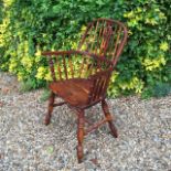 A SOLID YEW WOOD WINDSOR CHAIR With a pierced splat back, raised on ring turned legs.