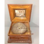 A LATE 19TH CENTURY WALNUT CASED AND FLORAL MARQUETRY INLAID POLYPHON  Complete with eleven discs.