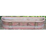 AN EARLY 19TH CENTURY WOODEN PLANT TROUGH  With original salmon pink and gilt decoration.  (186cm