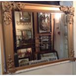 AN EARLY 19TH CENTURY GILT FRAMED OVERMANTEL MIRROR Applied with leaf and scroll decoration.