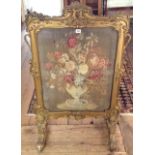 A 19TH CENTURY TAPESTRY FIRE SCREEN Contained in an elaborate gilt painted frame. (64cm x 107cm)