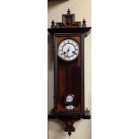 A 19TH CENTURY MAHOGANY AND EBONISED VIENNA WALL CLOCK With chiming movement, enamelled dial and