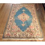 AN ANTIQUE WOOL WOVEN RUG Having a central rectangular blue field, with an unusual diamond shaped