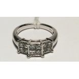 A HEAVY HALLMARKED PLATINUM AND DIAMOND DRESS RING The three graduated square clusters of four