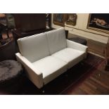 AN ITALIAN DESIGNER WHITE LEATHER TWO SEAT SETTEE Raised on a polished chrome supports.