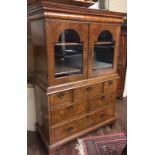 AN 18TH CENTURY DESIGN WALNUT CABINET The deep cushion cornice above an arrangement of drawers,