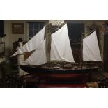 A LARGE WOODEN HULLED MODEL OF A SEA-GOING YACHT  Fully rigged.  Overall length: 267cm