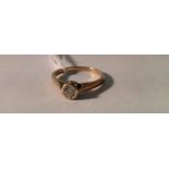 AN EARLY 20TH CENTURY 9CT GOLD, DIAMOND SOLITAIRE RING The round brilliant cut diamond in illusion