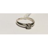 A HALLMARKED 9CT WHITE GOLD AND DIAMOND SOLITAIRE RING The round cut diamond illusion set, to
