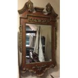 A LARGE 19TH CENTURY WALNUT AND PARCEL GILT FRAMED MIRROR With swan neck pediment, above a