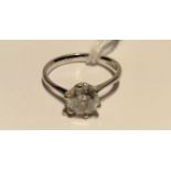 A HALLMARKED 18CT WHITE GOLD AND DIAMOND SOLITAIRE RING The brilliant cut diamond claw set, to plain