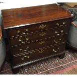 A GEORGIAN MAHOGANY CHEST  Of four long graduated drawers, fitted with brass furniture, raised on