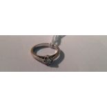 A 9CT WHITE GOLD AND DIAMOND SOLITAIRE RING The round brilliant cut diamond set to a tapering shank,