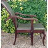 A LATE 19TH CENTURY MAHOGANY RECLINING CAMPAIGN CHAIR Having curved scrolling arms with carved