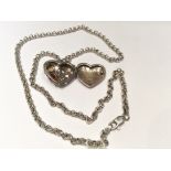 A SILVER AND GEMSTONE LOCKET AND CHAIN The heart form locket with a plain back and pierced foliate