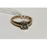 A HALLMARKED 9CT TWO COLOUR GOLD AND DIAMOND SOLITAIRE RING The brilliant cut diamond collet set