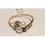 A MIKIMOTO 18CT GOLD AND CULTURED PEARL DRESS RING Set with two 4mm cultured pearls peg set to a