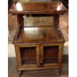 A SMALL VICTORIAN HIGH WALNUT SIDE CABINET With brass gallery, columns and two glazed doors,