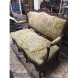 A LATE 19TH CENTURY CONTINENTAL WALNUT TWO SEATER SETTEE In Aubusson tapestry upholstery.