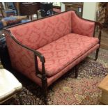 A 19TH CENTURY SHERATON DESIGN MAHOGANY FRAMED TWO SEATER SETTEE Raised on six legs on brass