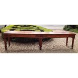 A LATE 19TH CENTURY MAHOGANY REFECTORY TABLE With carved apron, raised on six turned legs, seats