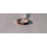 AN 18CT GOLD, DIAMOND AND RUBY RING The three round brilliant cut diamonds divided by two pairs of