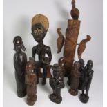 8 assorted Wooden Carved African Figures and Chinese Bronze Buddha.