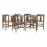 A set of six oak armchairs, with pierced splats and dished seats, one stamped 'Liberty & Co.' (6)