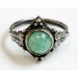 An Arts and Crafts silver amazonite ring, c.1930, with a circular cabochon amazonite, rub set in a