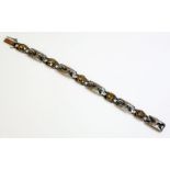 An and Arts and Crafts sterling silver smokey quartz bracelet, by Liberty, with a series of circular