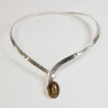 A Continental modernist torque style tiger's eye necklace, c.1970, a flat section, graduated torque,