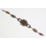 An Arts and Crafts bloodstone and coral bracelet, c.1910, by Zoltan White & Co., with a