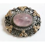 An Arts and Crafts silver and gold, rose quartz brooch, attributed to Bernard Instone, an oval