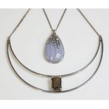 A sterling silver smokey quartz bib necklace, c.1970, by Malcolm Gray, a curved crescent centrepiece